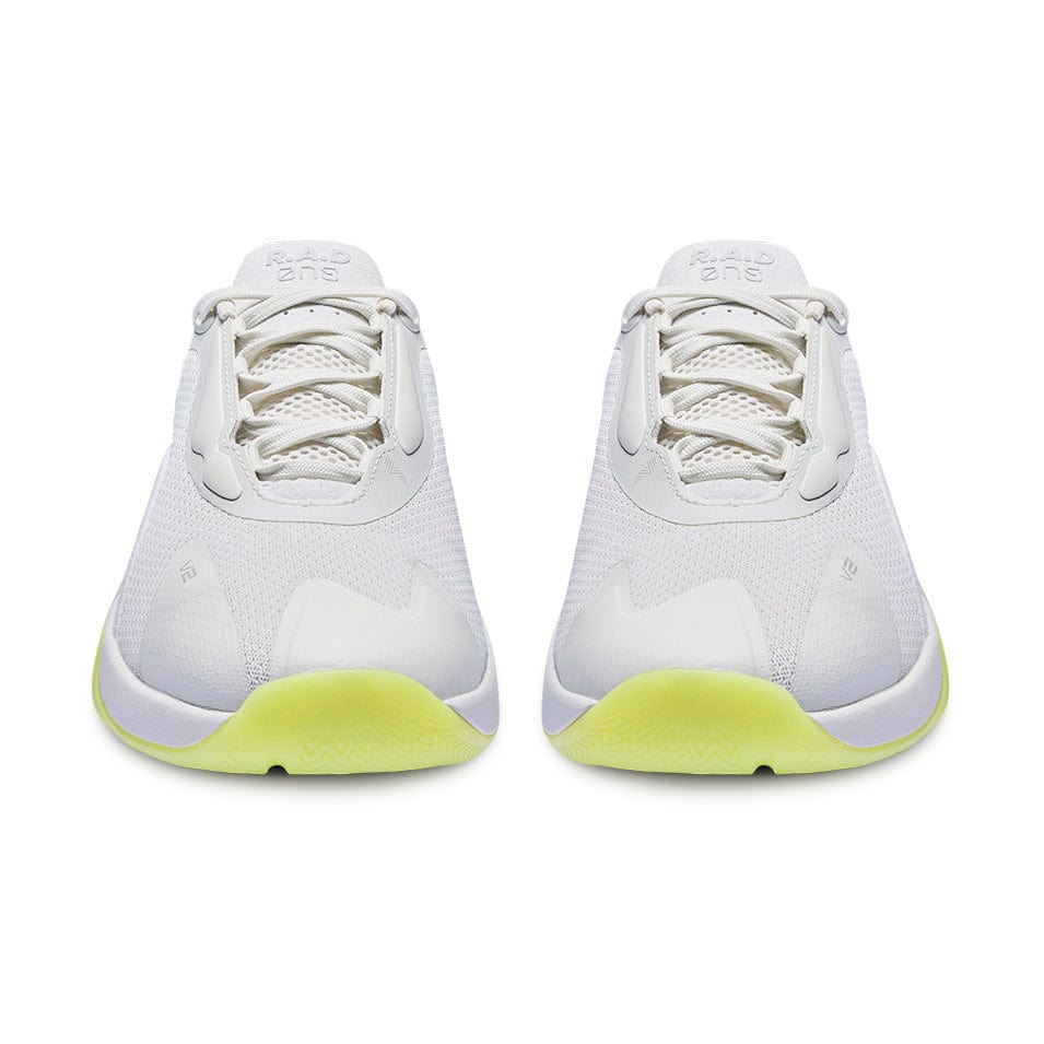 Pair of white athletic shoes with yellow soles.