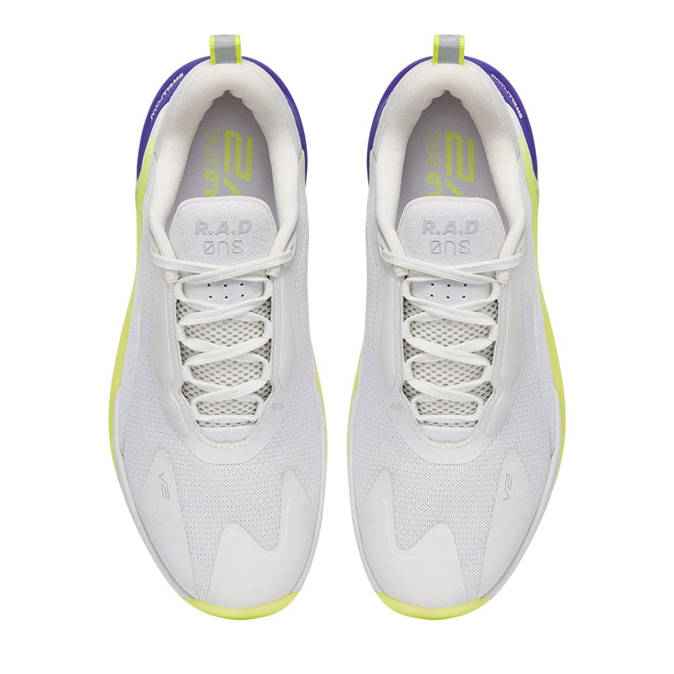 Pair of white athletic shoes with neon yellow and purple accents.