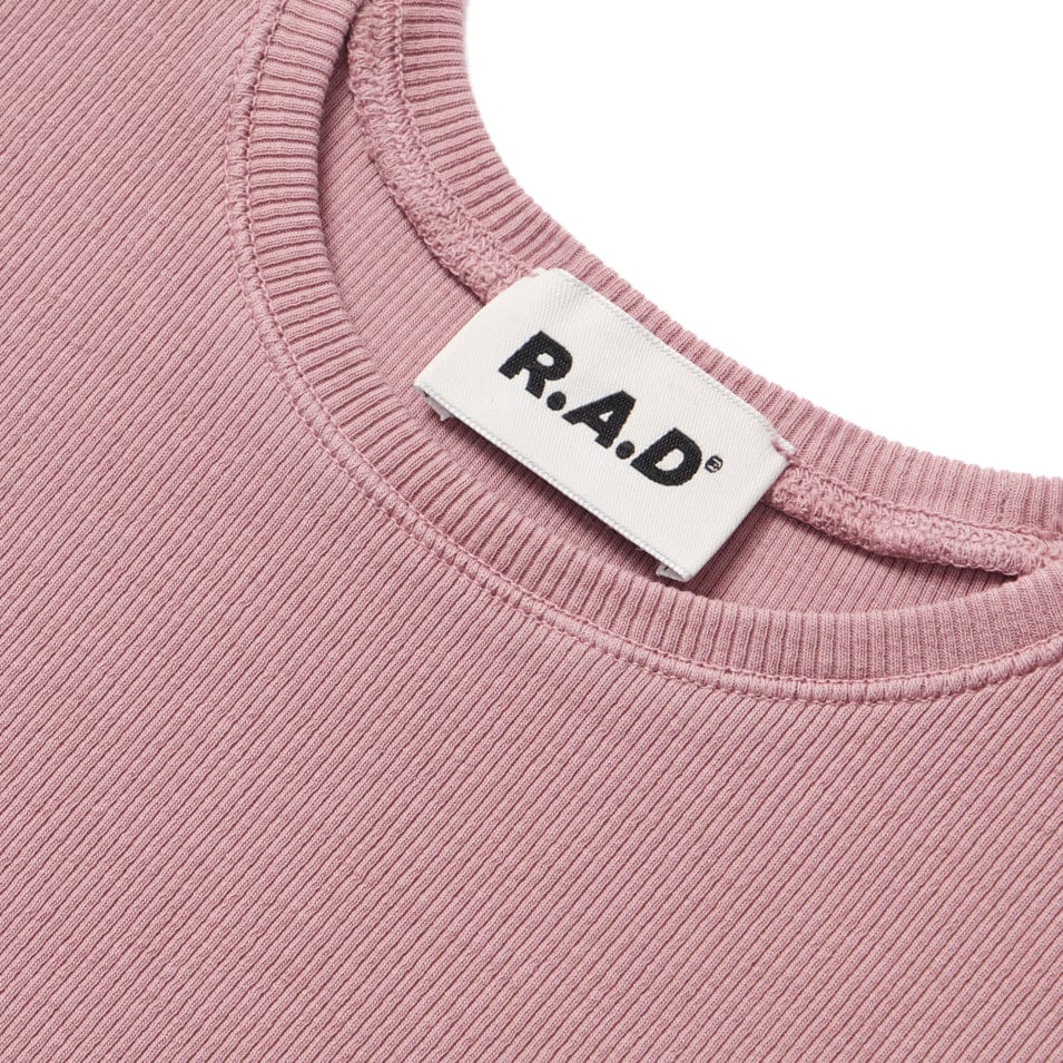 Pink ribbed knit top with brand label.